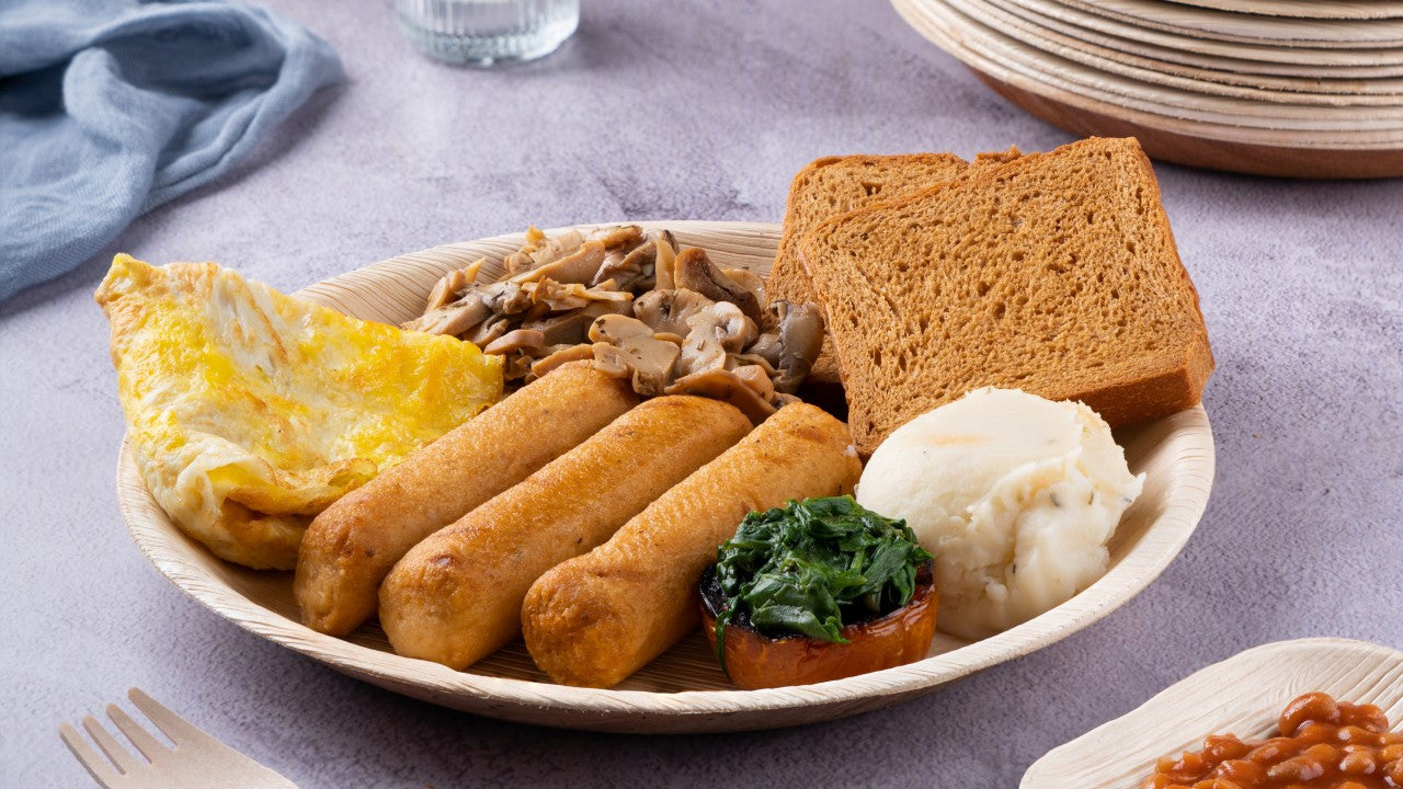 Disposable 10" round areca palm leaf plate shown with a meal on it. These plates are durable and can handle all kinds of foods!