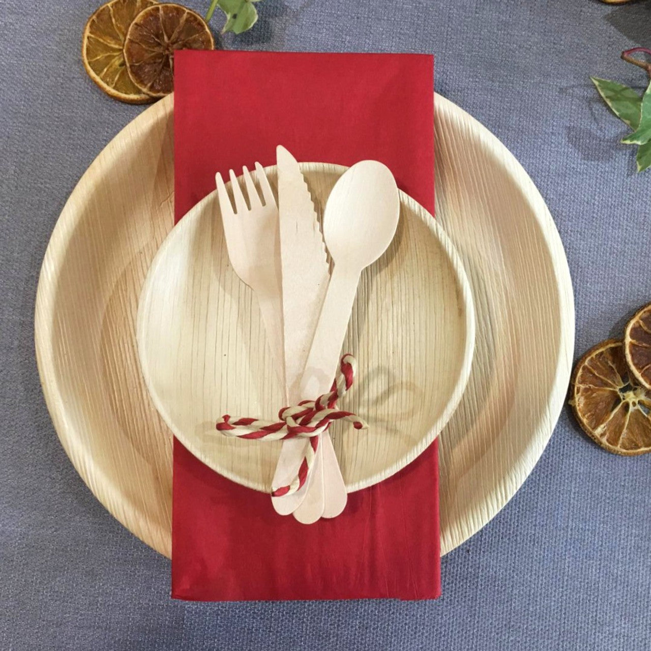 10" round areca palm leaf plate and utensils on a table setting. Perfect for large parties such as weddings, or just a family dinner on Sunday night!